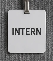 The badge. It says INTERN, it will keep saying INTERN.